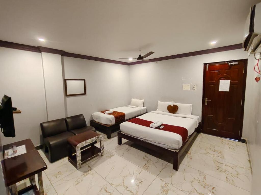 Ένα ή περισσότερα κρεβάτια σε δωμάτιο στο Sunrise Beach Resort