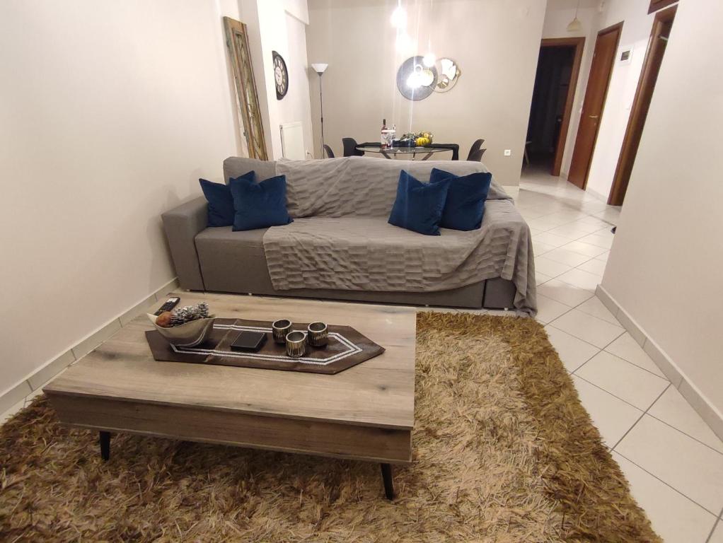 a living room with a couch and a coffee table at George's Family house in Larisa