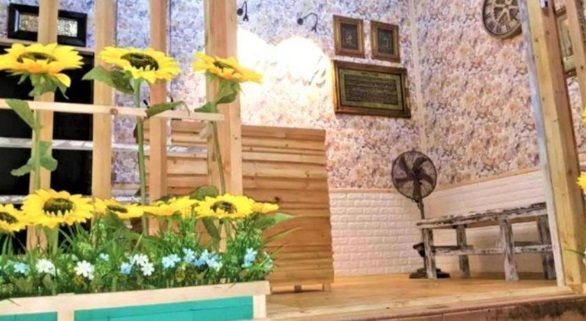 a room with sunflowers on the wall at Hijrah Hotel, Alor Setar in Kampong Alor Bekong