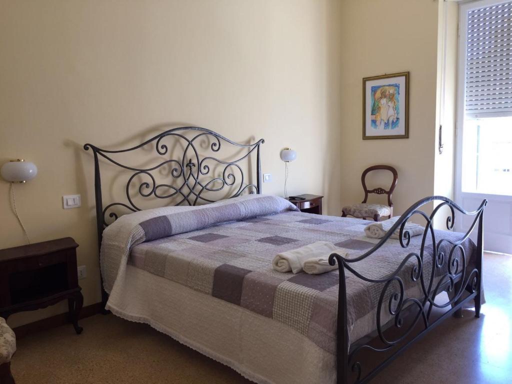 a bedroom with a black bed with a blanket at Affittacamere del viaggiatore in Ancona