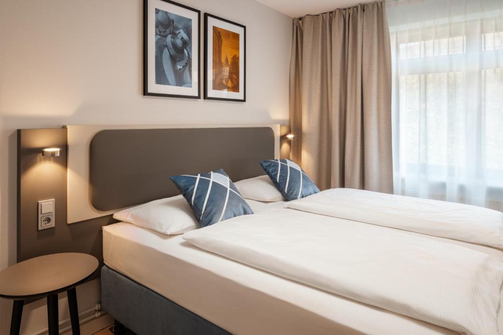 Ένα ή περισσότερα κρεβάτια σε δωμάτιο στο GHOTEL hotel & living Hannover