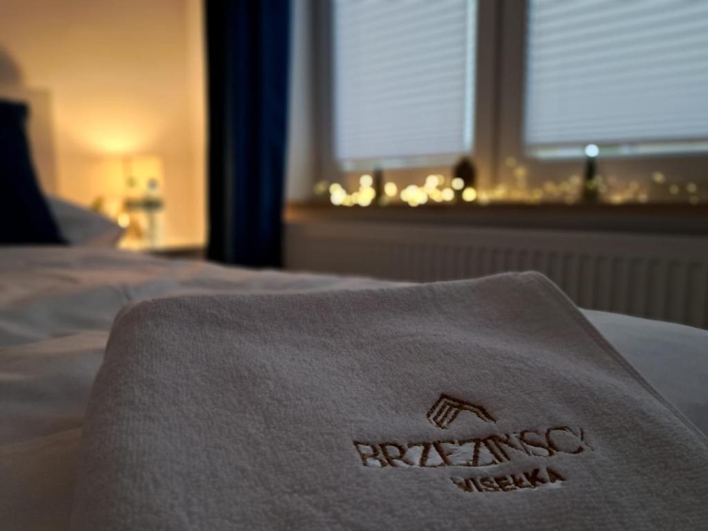 a towel on a bed in a hotel room at Brzezińscy Pensjonat Wisełka in Wisełka