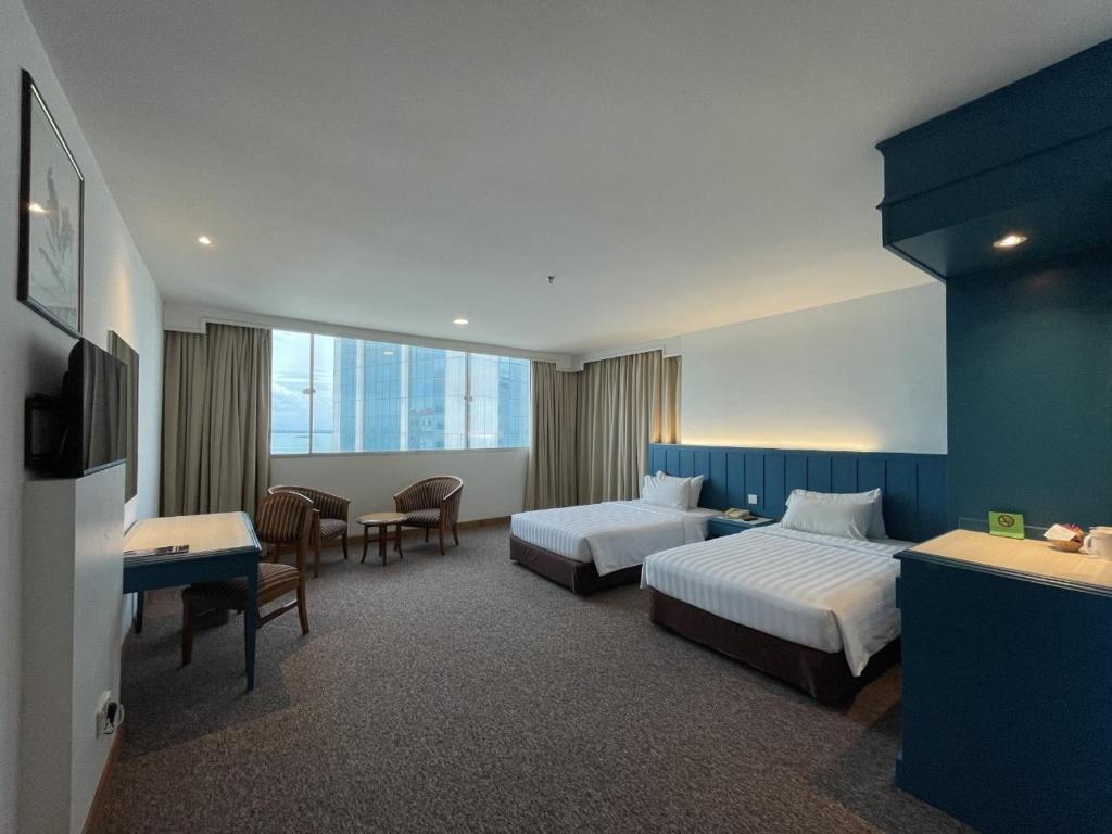 Ένα ή περισσότερα κρεβάτια σε δωμάτιο στο Hotel Continental Penang