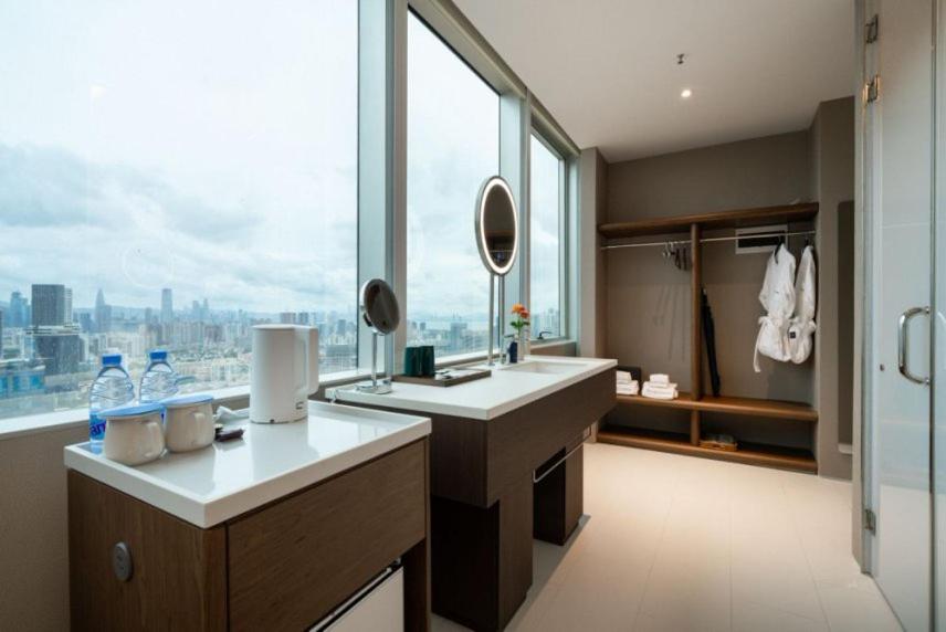 a bathroom with a sink and a large window at Calmsea Hotel in Shenzhen