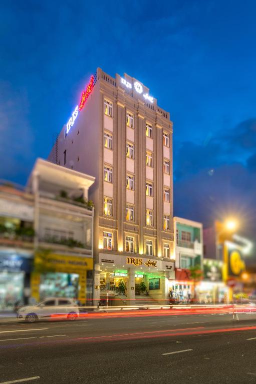a building with a sign on top of it on a street at Iris Hotel Đà Nẵng in Danang