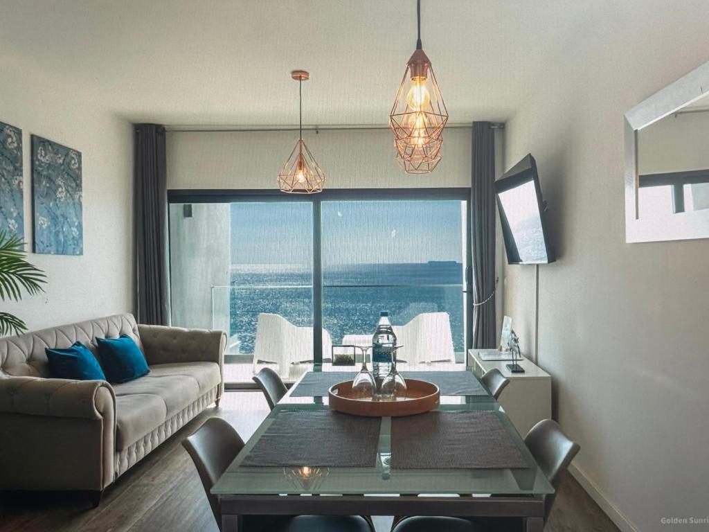 a living room with a couch and a table with a view at Tranquil Escape in Gaula