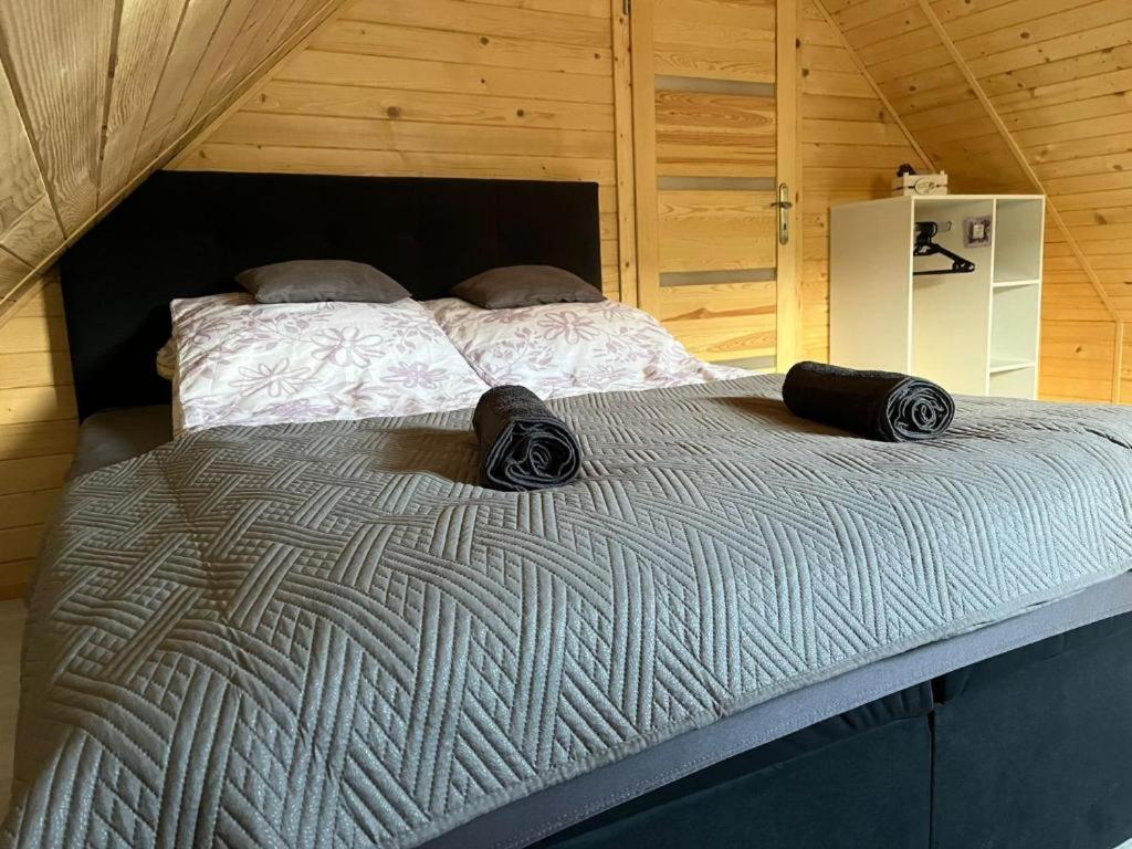 a large bed with two pillows on top of it at Agroturystyka Lawendowa Dolinka Domki Beskid Niski in Chyrowa