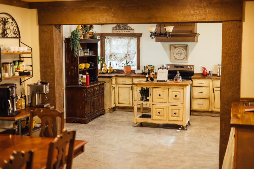 a large kitchen with wooden cabinets and a table at Escape to Villa Serena in Dahlonega