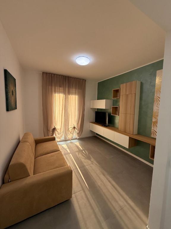 a living room with a couch and a window at Appartamenti Rugacesio 24 - B in Pioltello