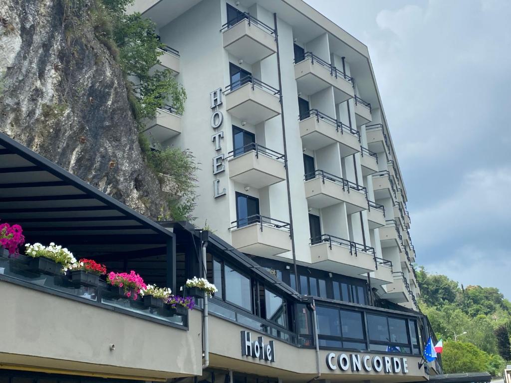 a building with flowers on the balconies of it at Hotel Concorde in Arona