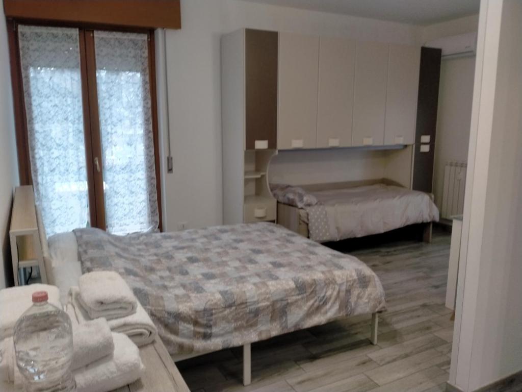 une chambre avec deux lits et une table avec des serviettes dans l'établissement Monolocale policlinico gb rossi borgo roma verona, à Vérone