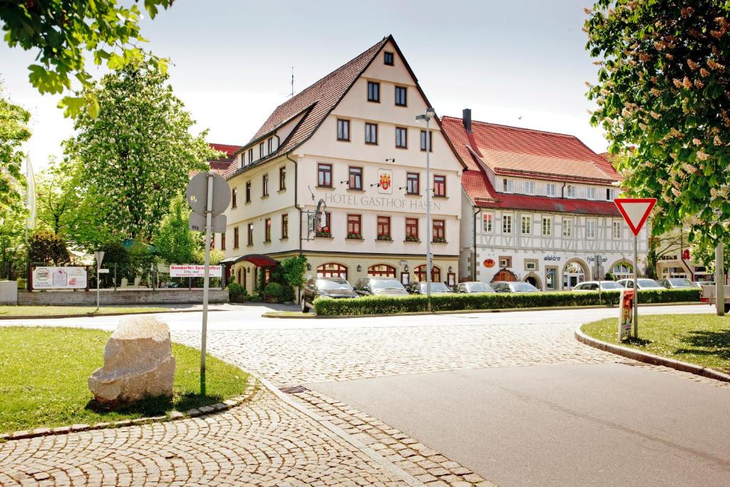 a large building on a street with a rock at Ringhotel Gasthof Hasen in Herrenberg