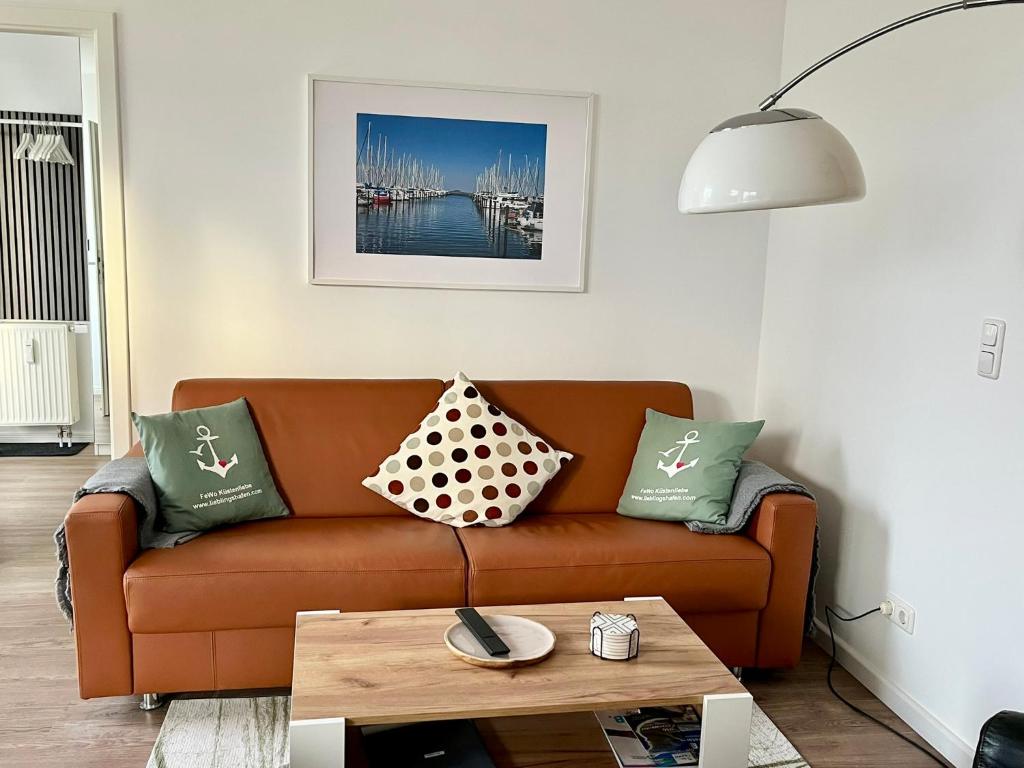 - un salon avec un canapé, des oreillers et une table dans l'établissement Küstenliebe, à Heiligenhafen