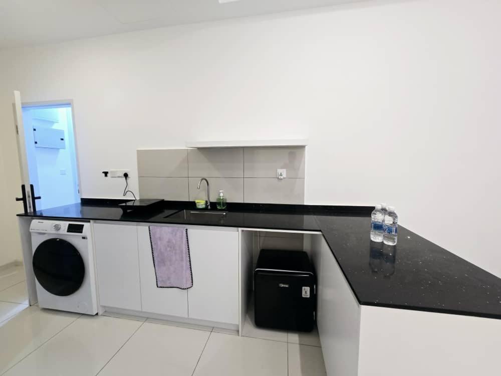 a kitchen with a sink and a washing machine at City centre Majestice Suite KLCC in Kuala Lumpur