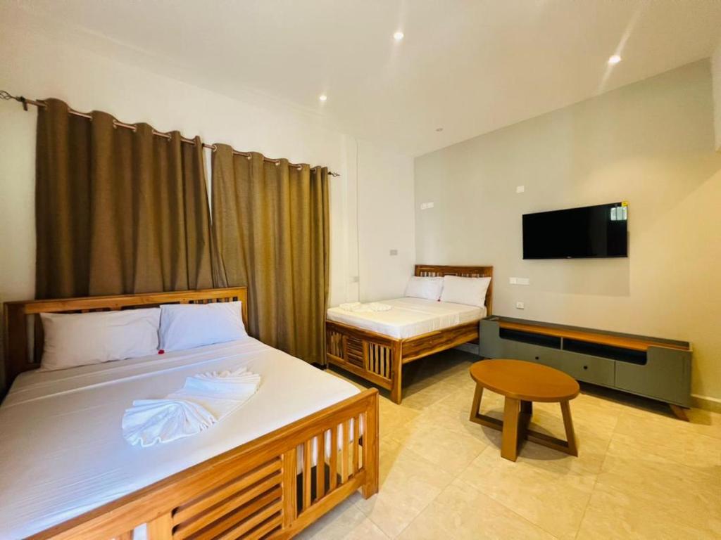 Postel nebo postele na pokoji v ubytování Mkunazini Heritage Hostels