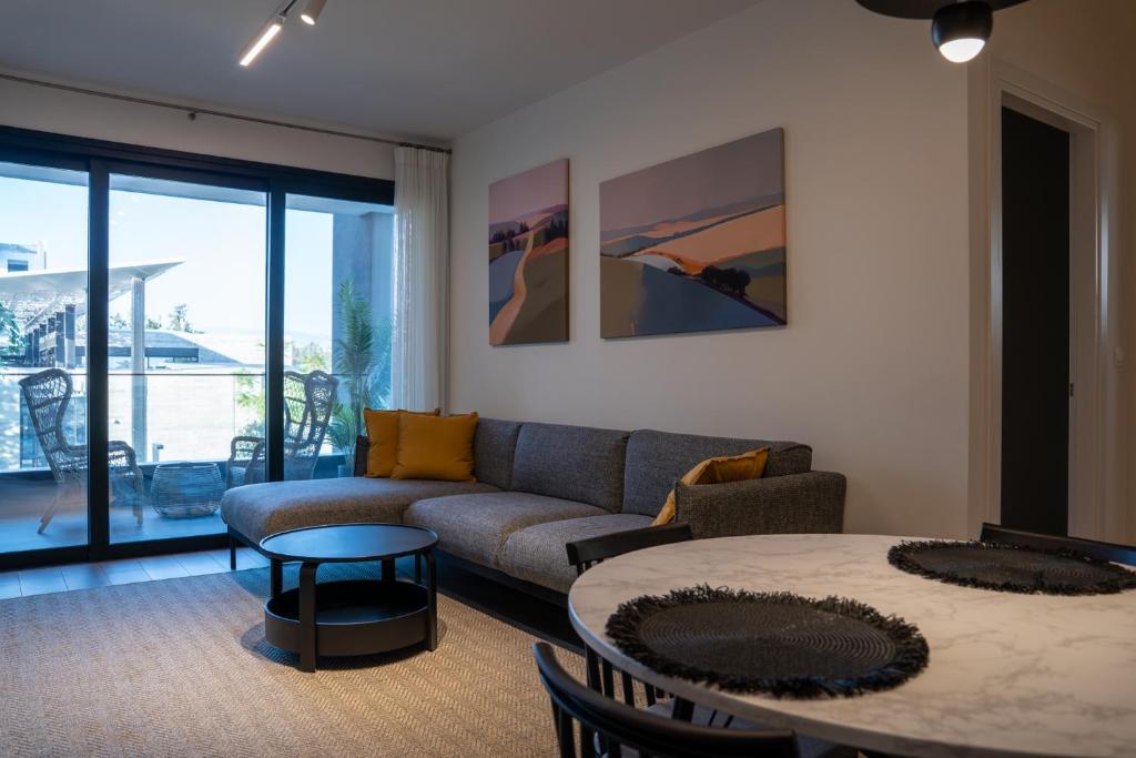 a living room with a couch and a table at Luxe One Residence in Aglantzia