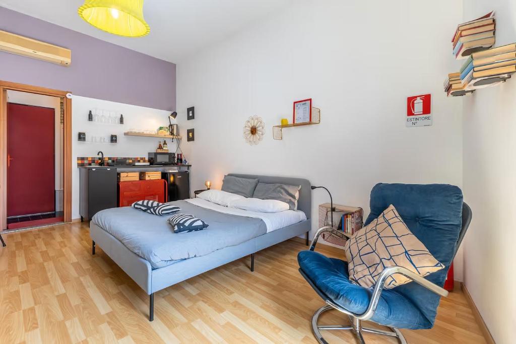 a living room with a couch and a chair at La stanza Modicana in Modica