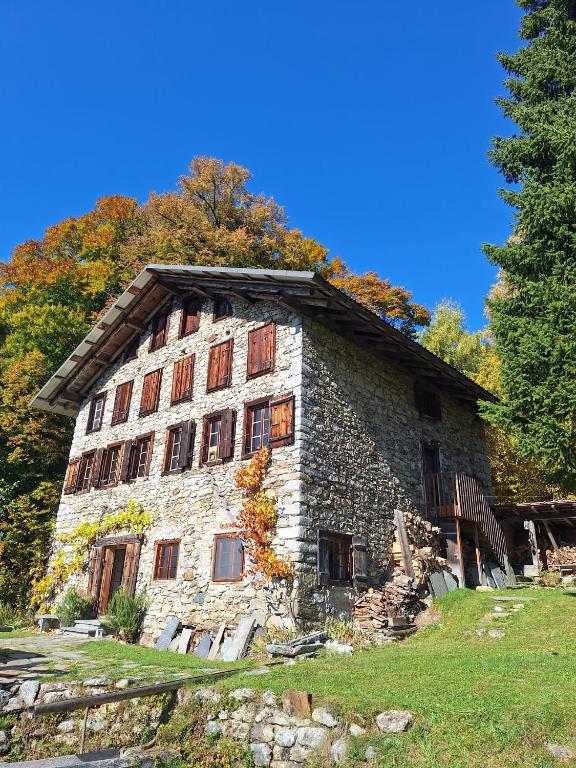 an old stone building with trees in the background at Rauft-Perfekter Rückzugsort für besondere Feierlichkeiten 2500 m2 Grundstück mitten in der Natur in Hasliberg