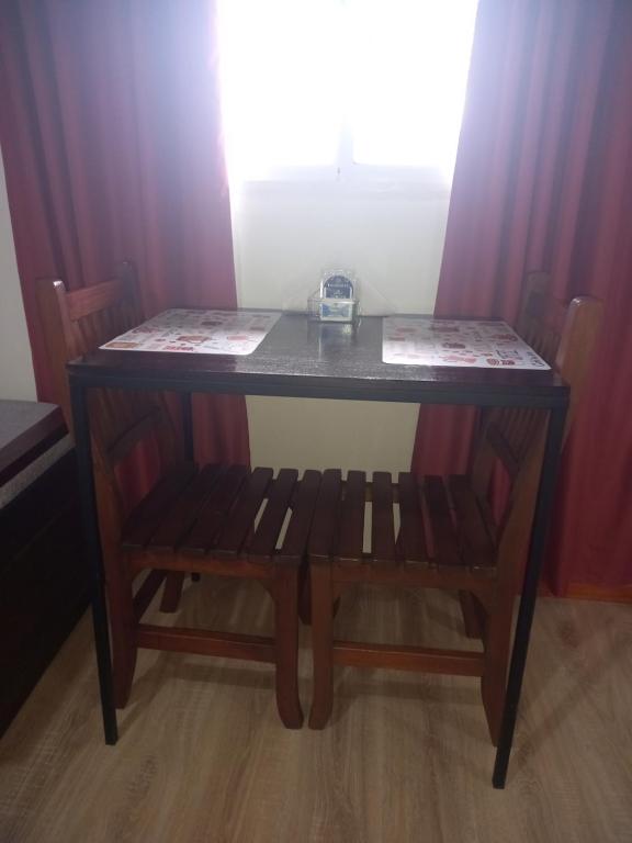 a table with two chairs and a table with a bench at Babella 2 in Concordia