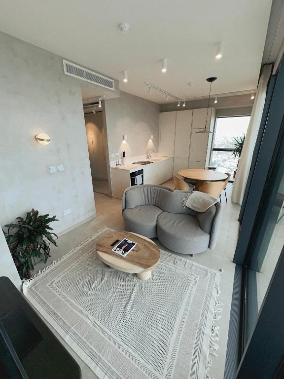 a living room with a couch and a table at Luxury 360 Sea View 27th Floor Apartment in Mercury Tower in St. Julianʼs