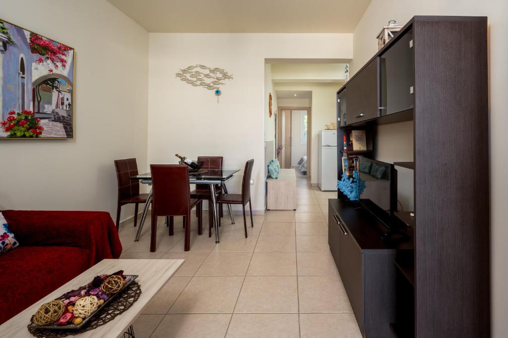 a living room with a red couch and a table at Levanta Cozy Apartment #1 in Kalavarda Rhodes in Kalavárda