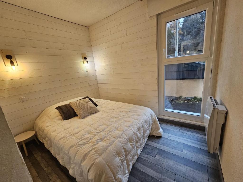 a bedroom with a bed and a window at Cozy 1-room apartment with veranda and parking in Font-Romeu