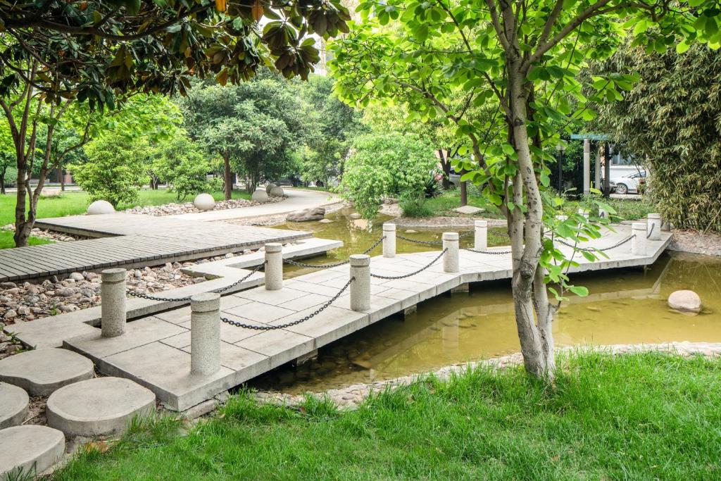 a bridge over a river in a park at Holiday Inn Zhengzhou Zhongzhou by IHG in Zhengzhou