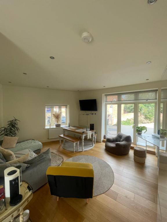 a living room with a couch and a table at Boho Bliss in Towcester in Towcester