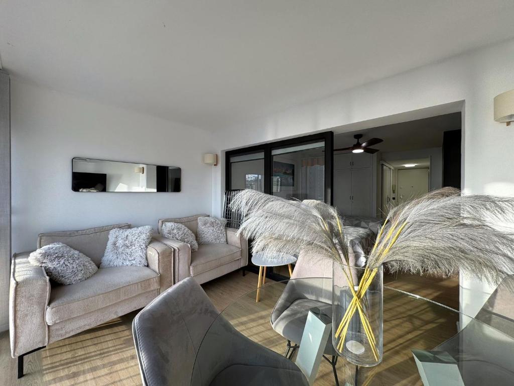 a living room with two couches and a table at Albatros 13º in Benidorm