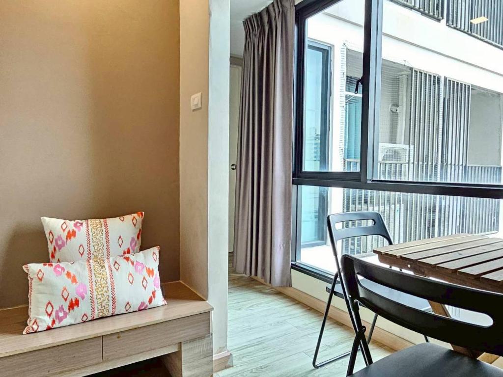A bright sitting and dining corner beside a large window.