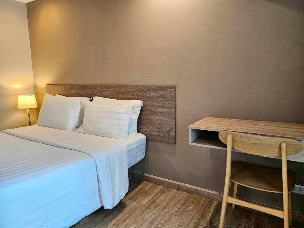 A bedroom corner with a double bed and a small built-in desk.