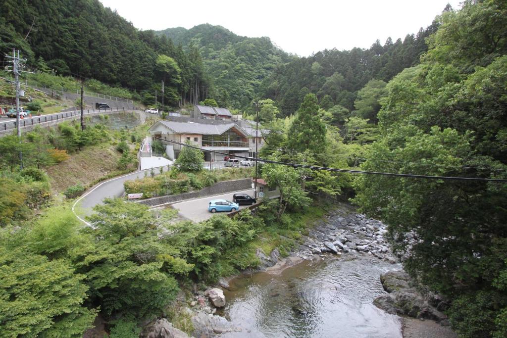 a car parked on a road next to a river at Yadori Onsen Iyashinoyu in Hashimoto
