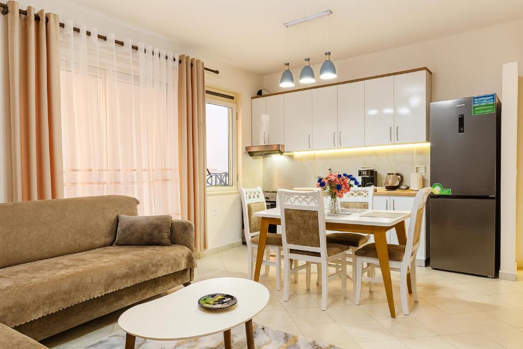 une cuisine et un salon avec un canapé et une table dans l'établissement ALBis apartments 1, à Tirana