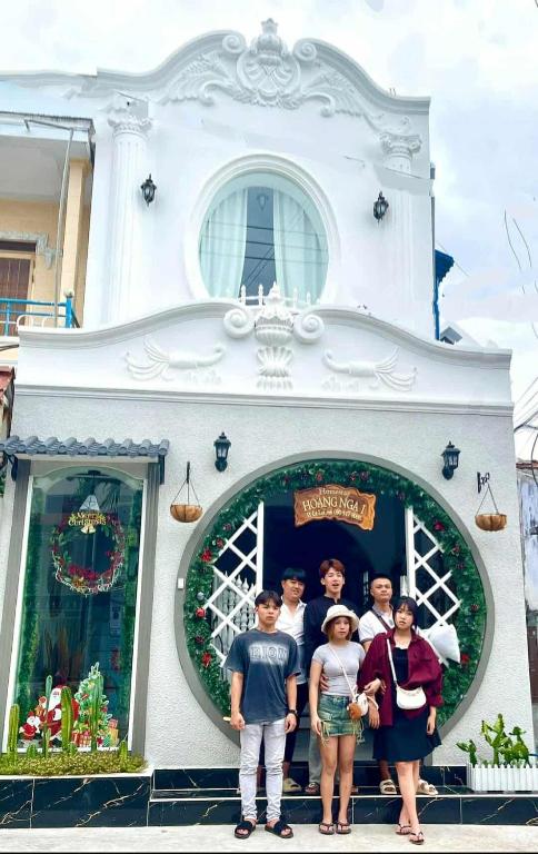 a group of people standing in front of a house at Hoàng Nga 1 Apartment in Phan Thiet