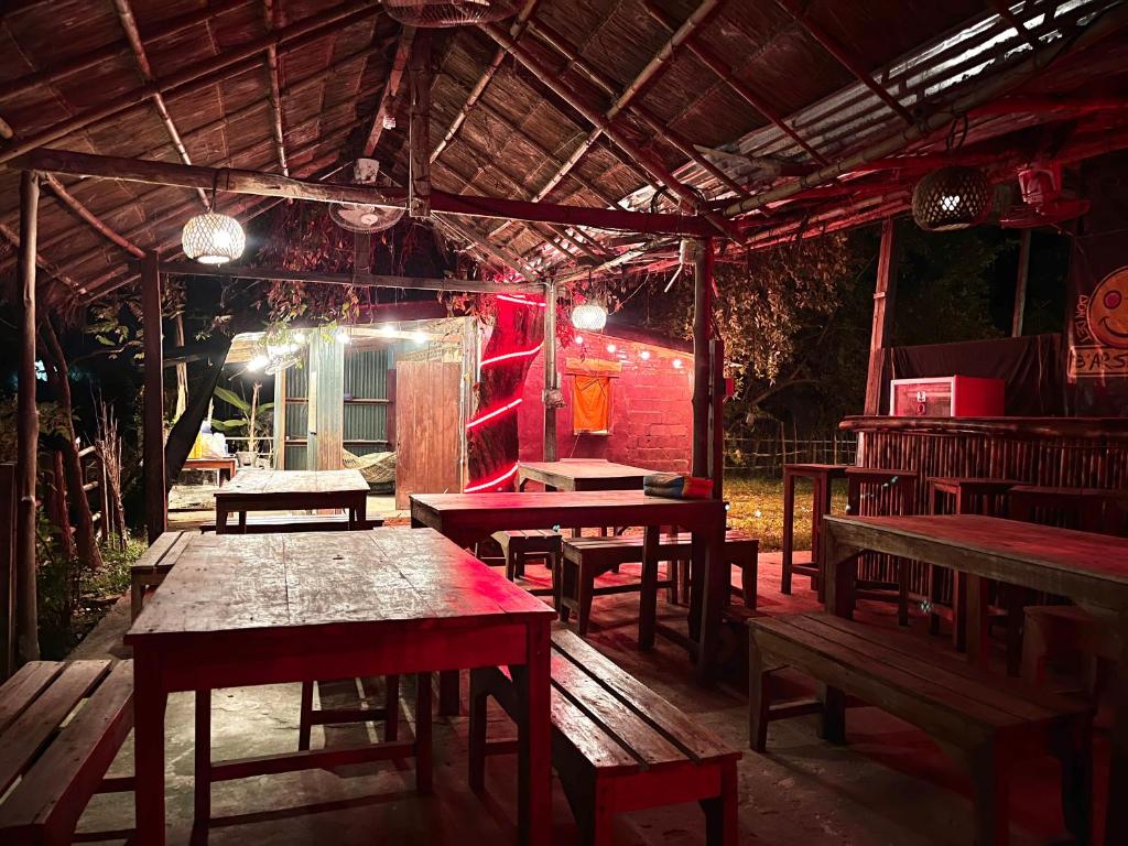 a group of tables and benches in a restaurant at The Last Resort in Don Det