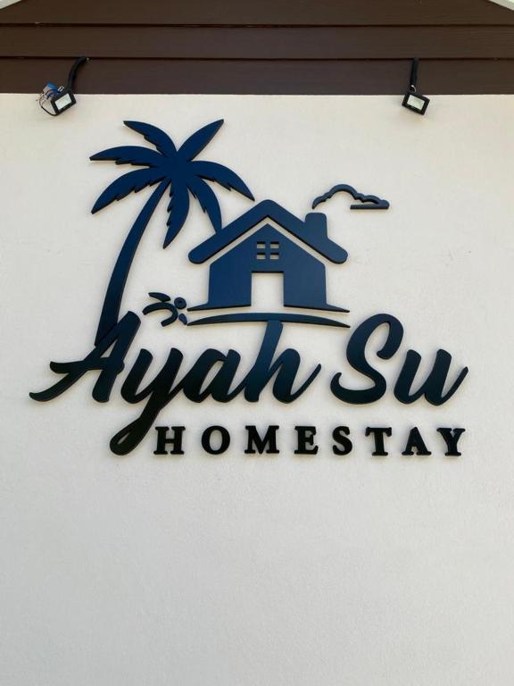 a sign for a hawaiian homestay with a palm tree at Ayah Su Homestay Atas Tol in Kuala Terengganu
