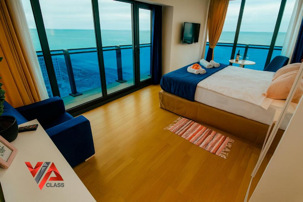 a bedroom with a bed and a view of the ocean at VIP CLASS ꙳ ORBI CITY in Batumi