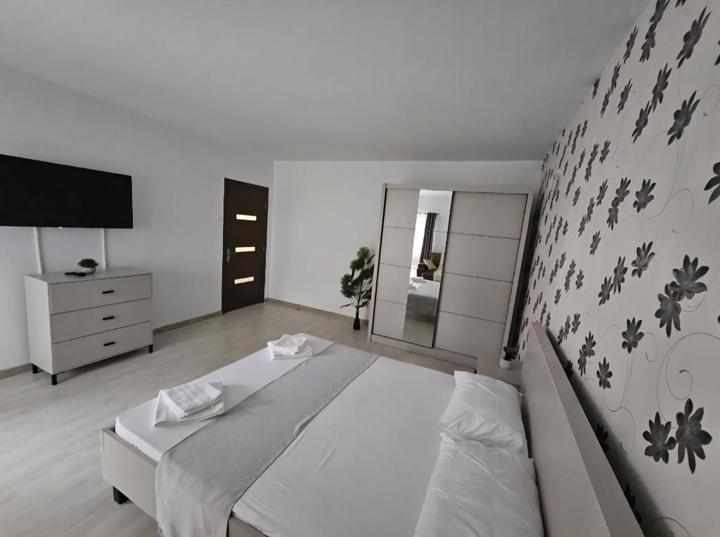 ein Schlafzimmer mit einem großen Bett und einem Spiegel in der Unterkunft Lovely apartment in Craiova