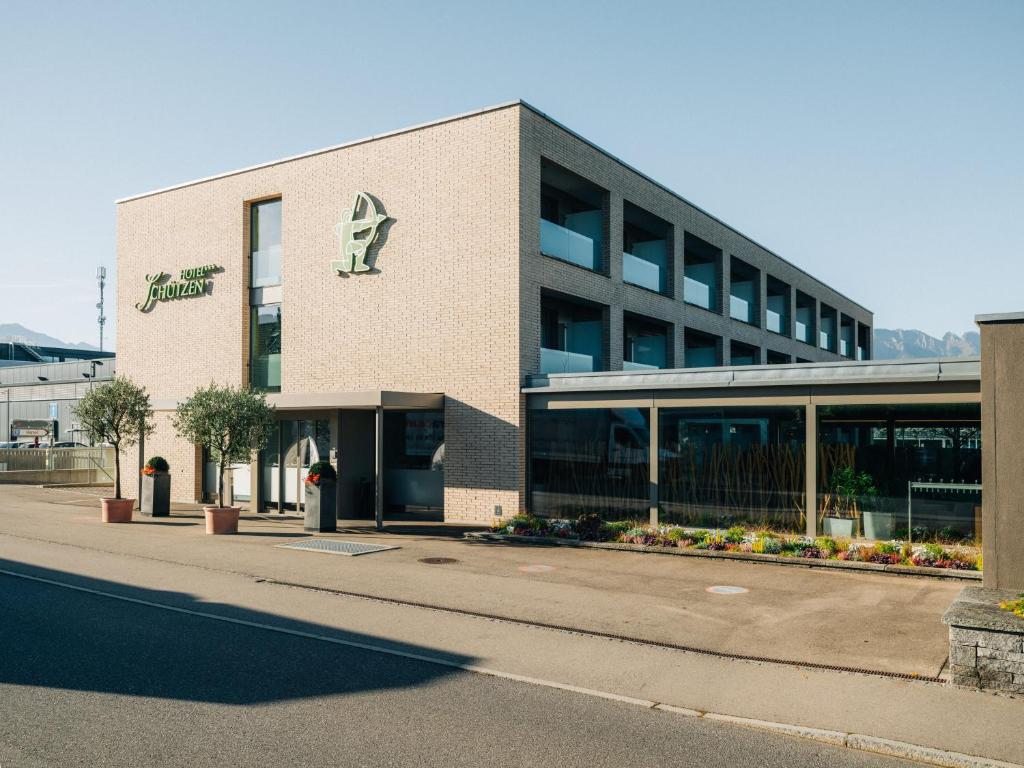 a building with a parking lot in front of it at Schützen Steffisburg in Thun
