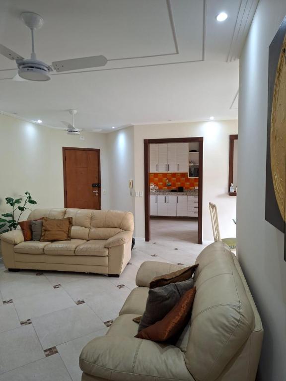 ein Wohnzimmer mit zwei Sofas und einer Couch in der Unterkunft Apartamento Enseada in Guarujá