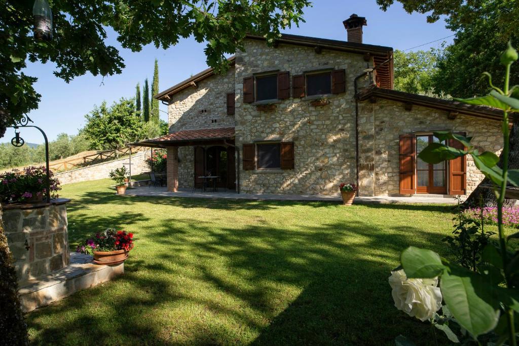 an external view of a stone house with a yard at Historic Farmhouse In The Tuscan Hills in Caprese Michelangelo