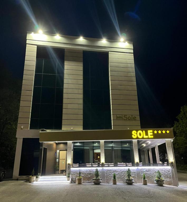 a building with a sold sign in front of it at night at Hotel Sole in Međugorje
