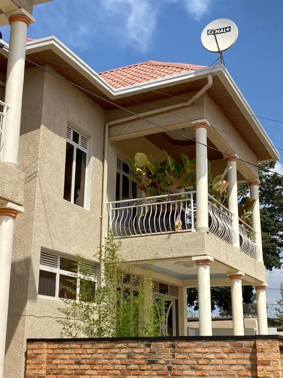 a large house with a balcony on top of it at KIGALI DYNAMICs HOMES AND HOTEL in Kigali