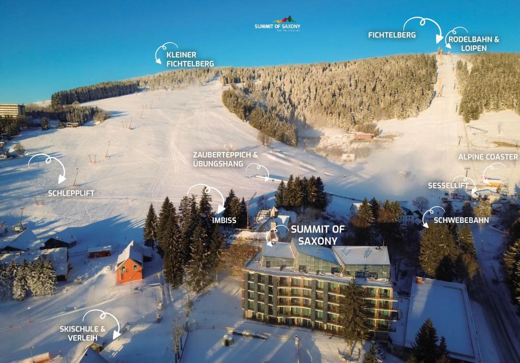 奥泊维森塔尔Summit of Saxony Resort Oberwiesenthal的雪地里滑雪胜地的正面景色