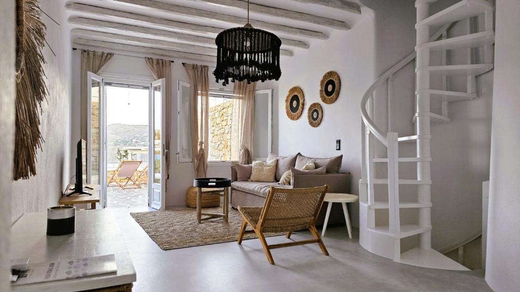 a living room with a couch and a table at Villa Spika with seaview and shared pool in Kalo Livadi