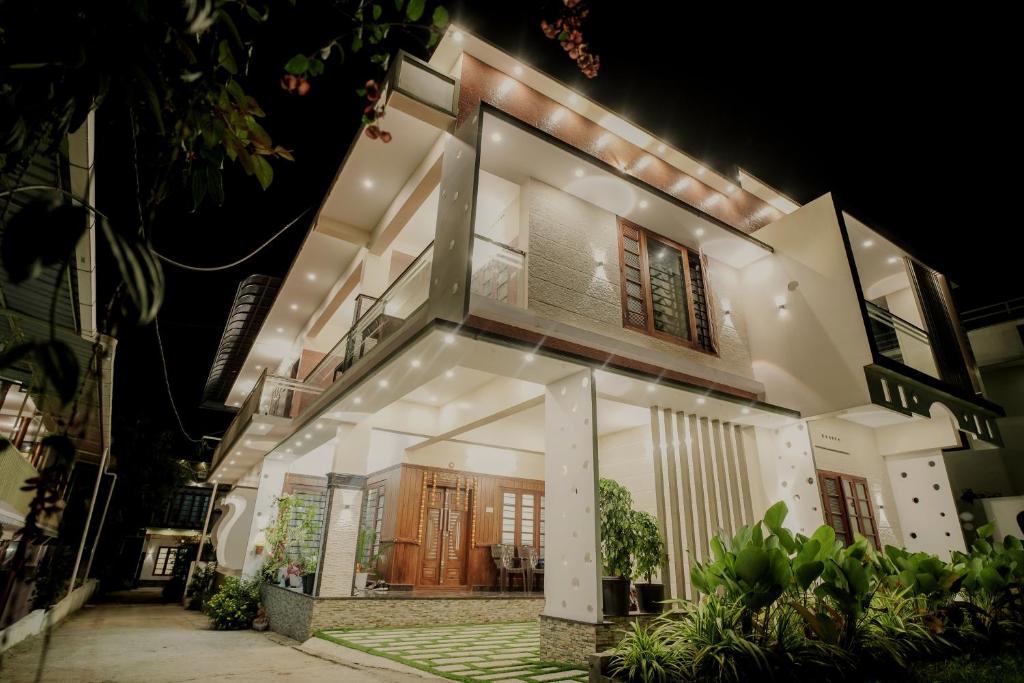 a large white house at night at Dean Dale Cottages in Thekkady