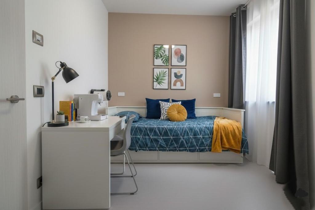 瓦雷泽BB Cadore casa vacanze的卧室里有一张床和一张书桌