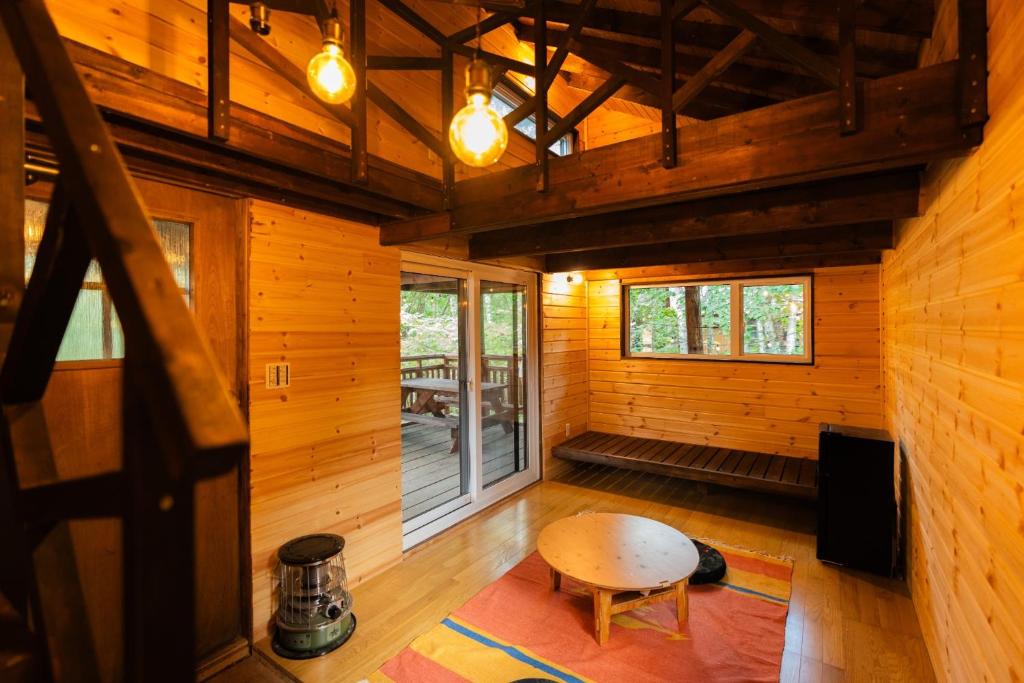 a room with a table in a wooden cabin at Playhouse Conifer - Vacation STAY 35448v in Mikage