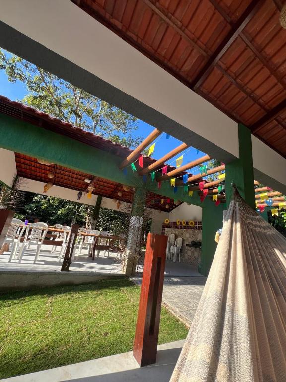 a hammock under a pavilion with a table at Apartamento Zion reserve suites in Conde