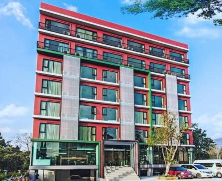 a red building with many windows at WE Valley Hotel in Chiang Mai